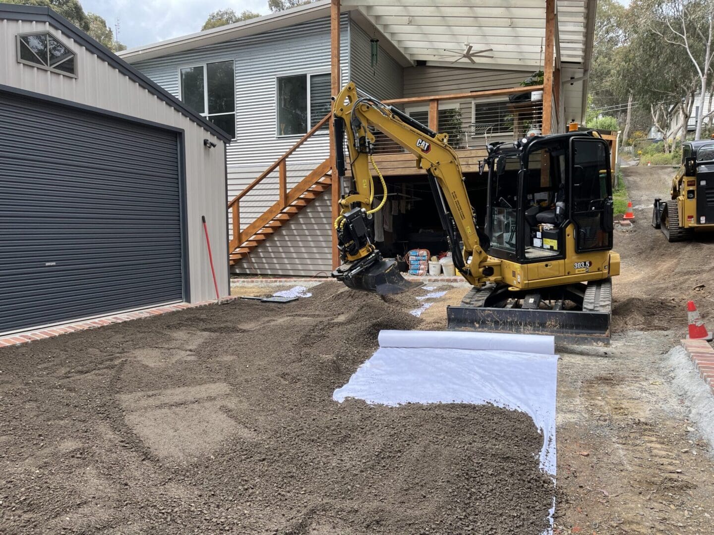 A landscaping machine working on a final trim excavation