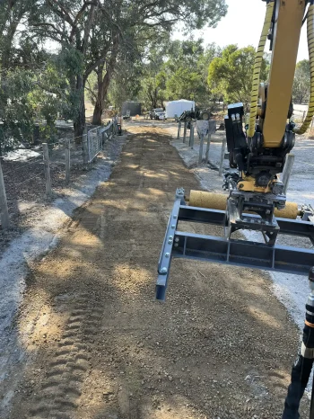 Leveling a rural driveway between horse paddocks.