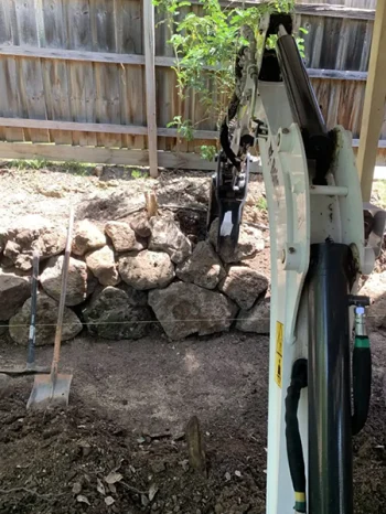 Bobcat Excavator building a Rock Wall